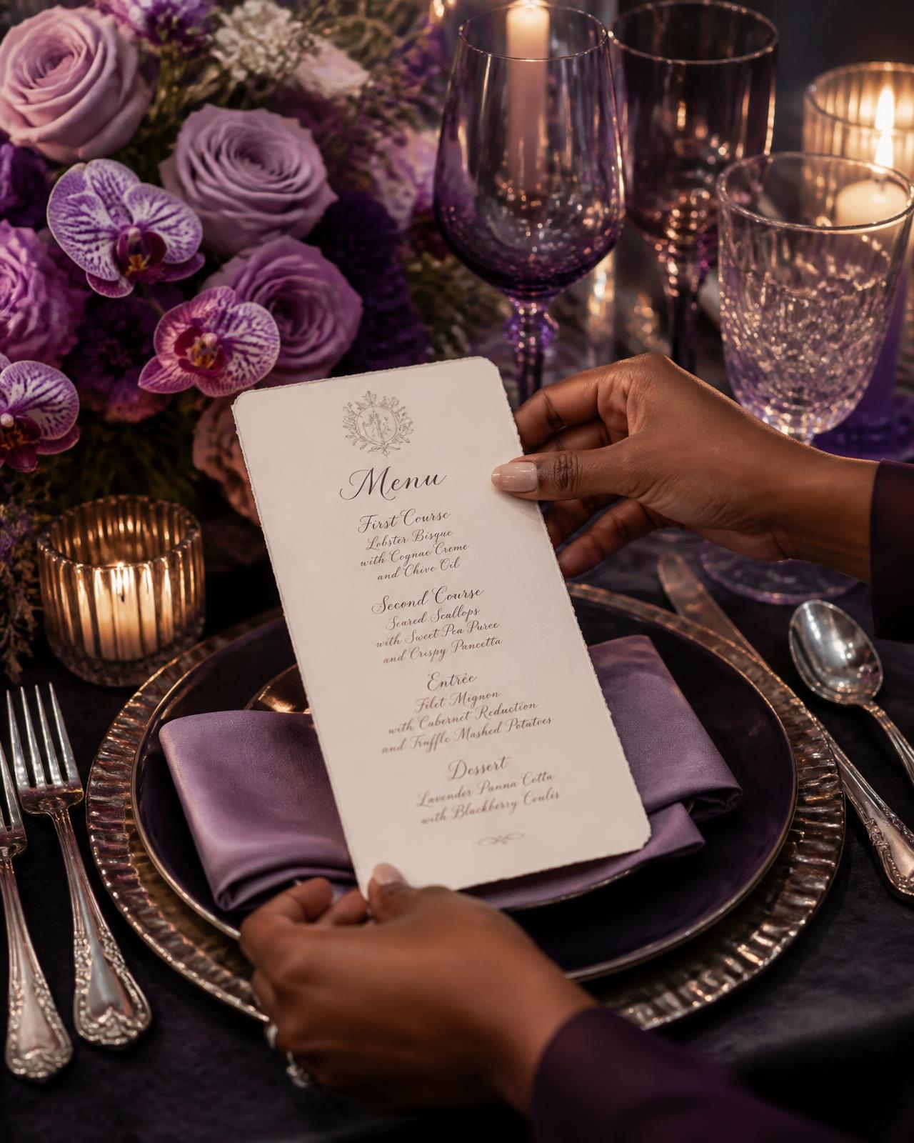 Hands placing a calligraphy menu card on a candlelit tablescape with lavender roses and purple orchids